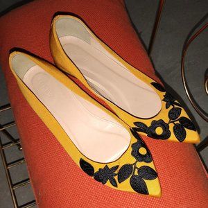 J. Crew flats with black embroidered floral on pointed toes.